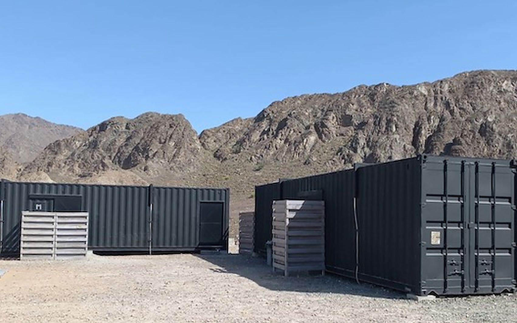 Two modified containers fitted as luxury bathroom units on a desert site