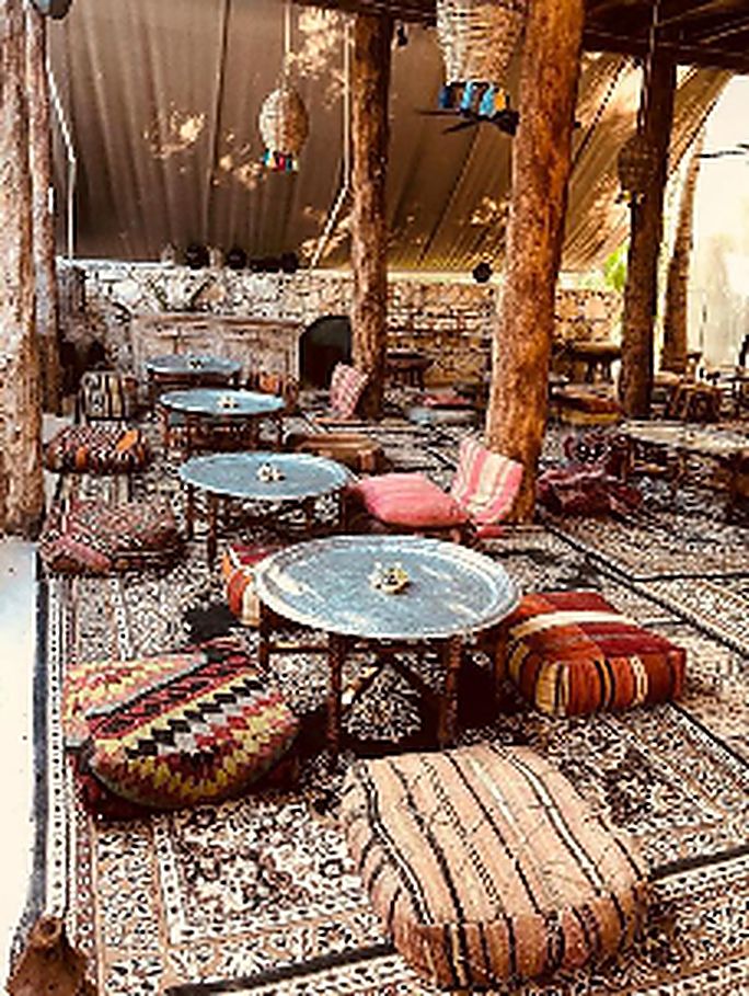 Majlis-style lounge dressed with rugs, low seating and cushions